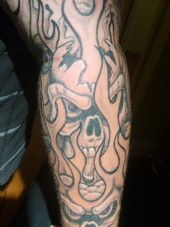 flame tattoo with skull tattoo design and leg tattoos