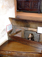 Priest in a hole under the stairs