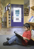 Young Boy reading the book