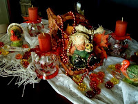 Dining Room Table -cornucopia filled with scarecrow and leaves and beads, turkeys, pumpkin glass beads, Autumn votive candle holders, pumpkin pie scented candles