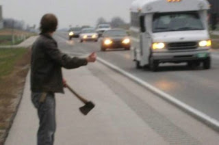 picture of a guy holding an axe and hitch-hiking
