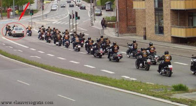 photo of a car knocking into two members of a motorcycle gang