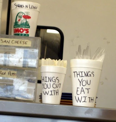 photo of funny writing on cups holding utensils