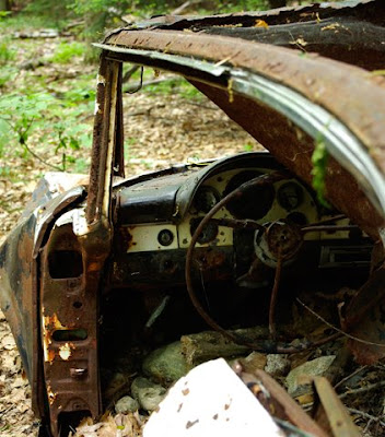 An abandoned, rusted Ford Fairlane