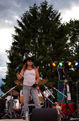 The lead singer for The Lynyrd Skynyrd Experience band playing at the Kiwanis Fireworks Festival