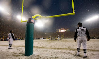 the referees watch a field goal through the snow