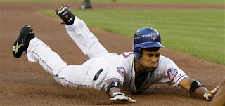 Endy Chavez slides into third after his RBI triple in the first inning