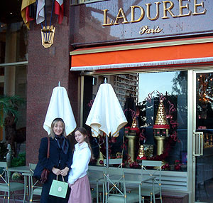 outside Laduree clutching bag of macaroons