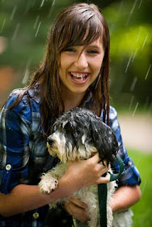 Girl in the rain with her pet dog