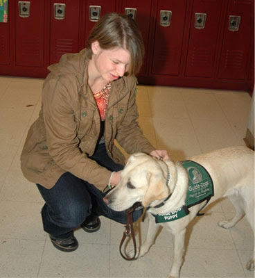 Puppy raiser Miranda Robertson, with puppy Candace