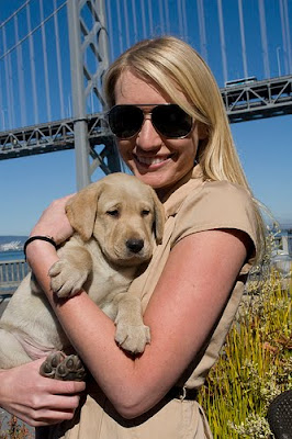 Molly Mahoney holding a yellow Lab puppy