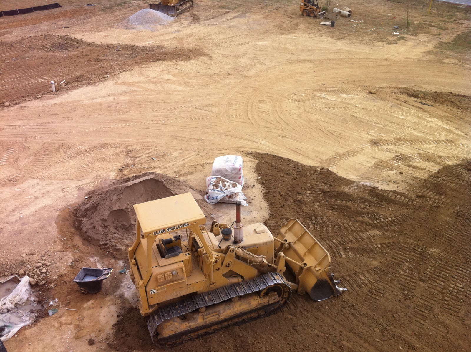 Charlestown LDS Spreading topsoil, hanging sprinkler pipe and asphalt