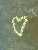 flower lei in the shape of heart floating on water