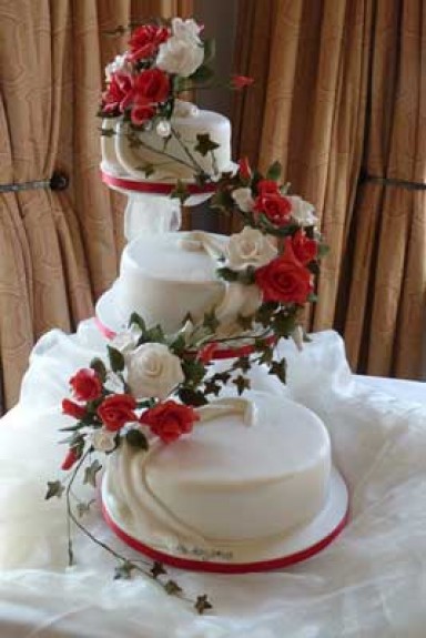 3 Tier Cascade Roses Three tier white cake with cascade red and white roses 3 Tier Cascade Roses Three tier white cake with cascade red and white roses