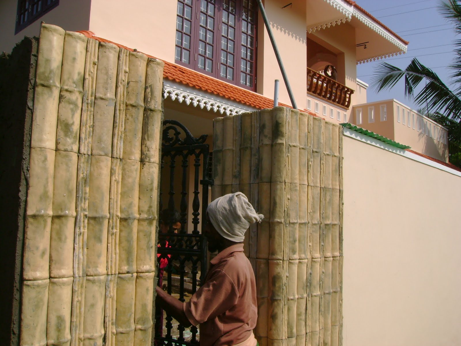 KeralaHouse Construction for Binu Thomas Gate pillars with bamboo design tiles
