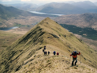 Hill walkers climbing Mweelrea in county Mayo Hill walkers climbing Mweelrea in county Mayo