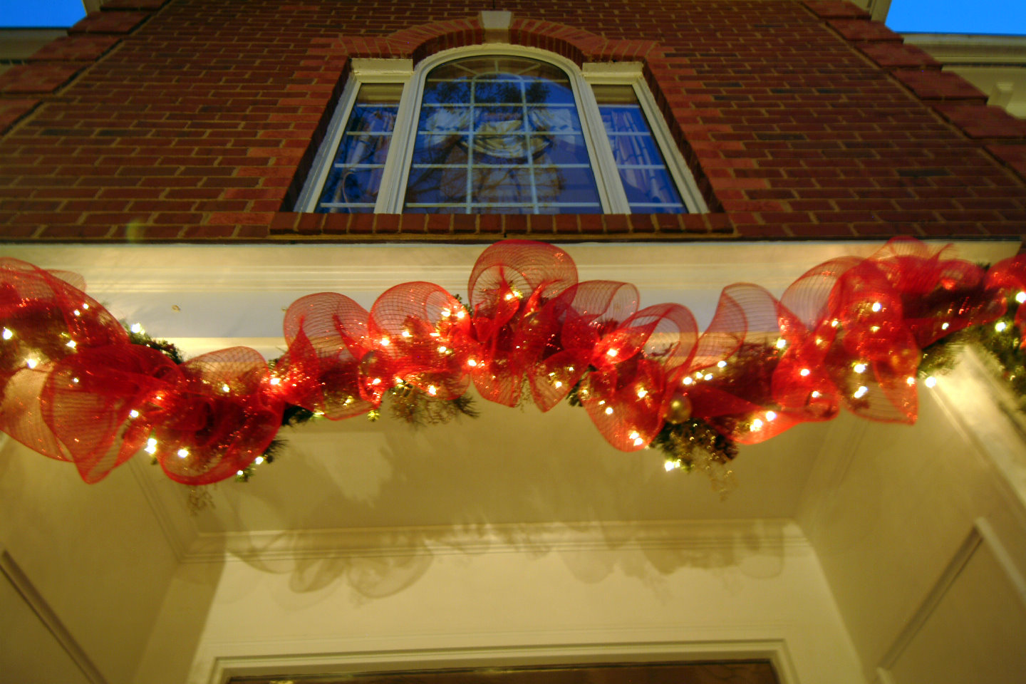 lighted red deco mesh garland over the door for christmas lighted red deco mesh garland over the door for christmas