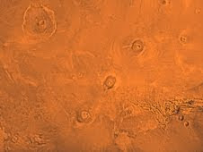 The Tharsis region of Mars, including the three volcanoes of Tharsis Montes (Arsia, Pavonis and Ascraeus Mons), as well as Olympic Mons in the upper left corner.