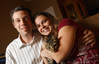 Seth and Kelly Levy hold their 10-month-old cat, Gracie Mae. Seth and Kelly Levy hold their 10-month-old cat, Gracie Mae.
