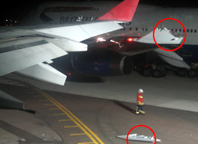 Part of one of the wing tips lies on the runway Part of one of the wing tips lies on the runway