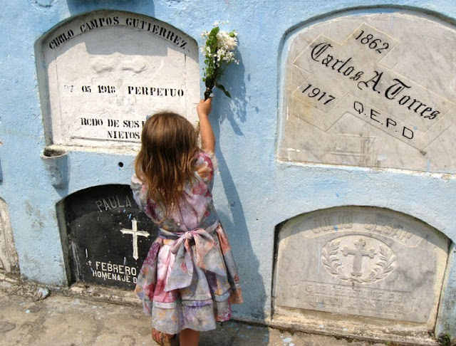 Young girl placing flowers