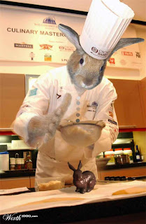 Funny Easter bunny in cook(chef) dress is cooking and decorating Easter chocolate bunny cake hot gallery
