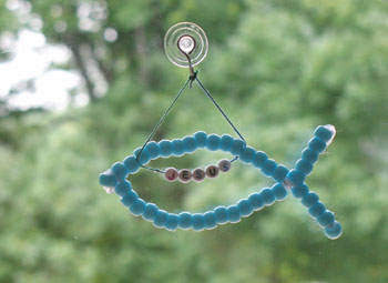Beaded fish with Jesus beads inside hanging from window