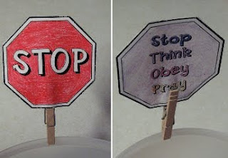 Paper stop sign with back reading "Stop, Think, Obey, Pray"
