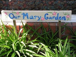 Wooden sign reading "our Mary garden"