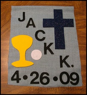 Blue bannker with decorations of a communion chalice, communion wafer and cross reading "Jack K. 4/26/09" 