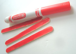 Popsicle sticks colored red with a red marker
