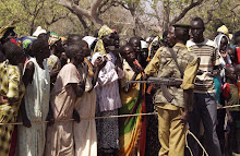 People a wait their turn to get food