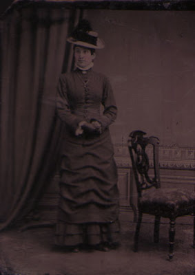 Woman Standing with Hat, High Collar, Necklace and Gloves