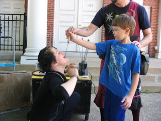 My son pulling a sword from a performer