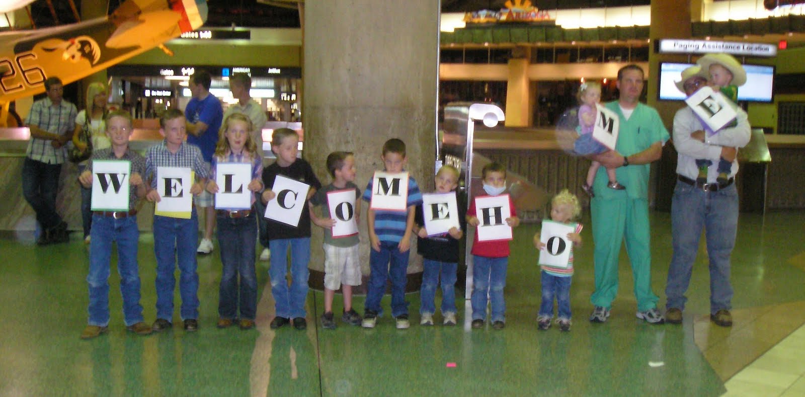 The grandkids holding the welco...