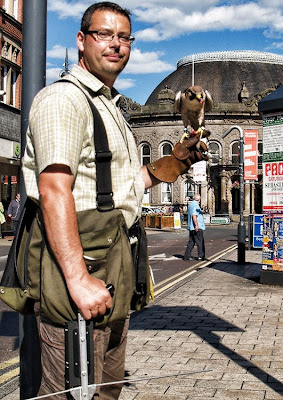 Picture of Lanner Falcon and falconer on Boar Lane Leeds with the corn exchange in the background Falcon Leeds City Centre