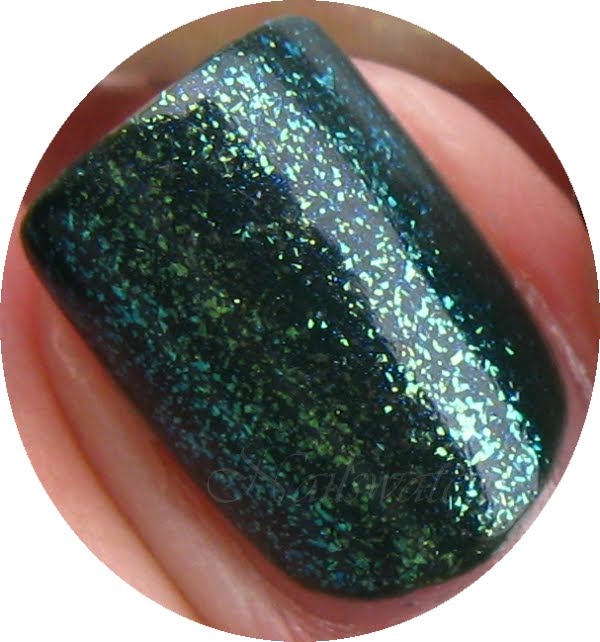 teal sparkle topcoat layering over orly enchanted forest nail polish