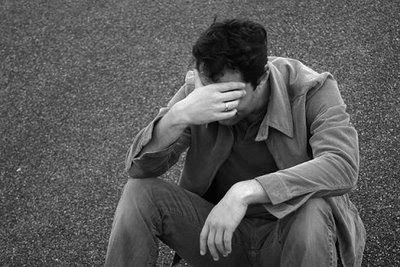 a very sad man sitting