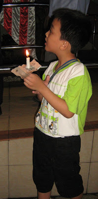 brave little boy with lighted candle to protest the grossly unjust ISA brave little boy with lighted candle to protest the grossly unjust ISA