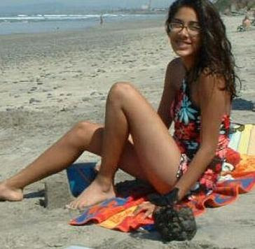 Hot nerd girl in happy mood at the beach