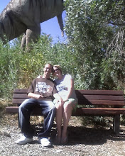 here is me and daniel sitting in front of the dinosaur at the park!!!!