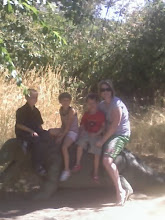 me, spencer, sissy, and jaden sitting on a  dinosaur!!!!!!