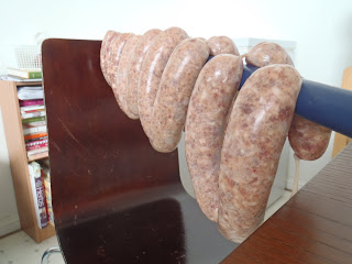 Hanging the sausage on a broom handle to dry the surfaces