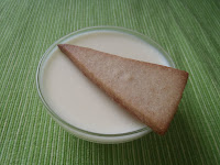 A cup of eating-posset and a shortbread cookie