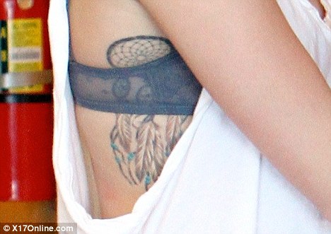 So not Undercover Miley Cyrus shows off dream catcher tattoo in lowcut 