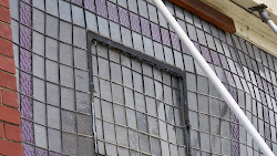 Stained lavender glass of an old building. broken & shattered in places, yet still lovely...