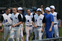 Trojans congratulate Dillon Creech (4) on his game winning hit