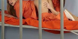 Two women in jail doing sex act.