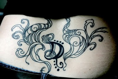 Floral With Letter Lower Back tattoo