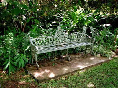 Wrought Iron Garden Bench on Wrought Iron Bench Can Easily Seduce A Garden Wanderer Into Stopping